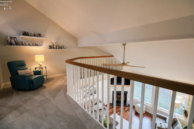 hall with a water view, vaulted ceiling, and carpet