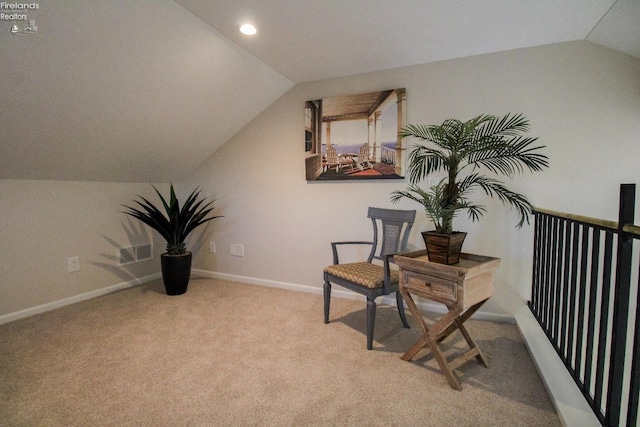 sitting room featuring lofted ceiling and light colored carpet