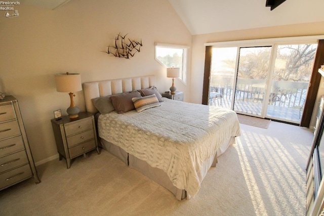 carpeted bedroom with access to exterior and vaulted ceiling