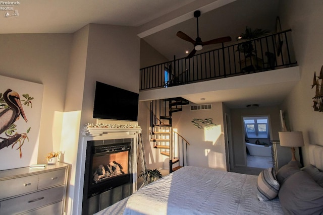 bedroom with a high ceiling and a multi sided fireplace