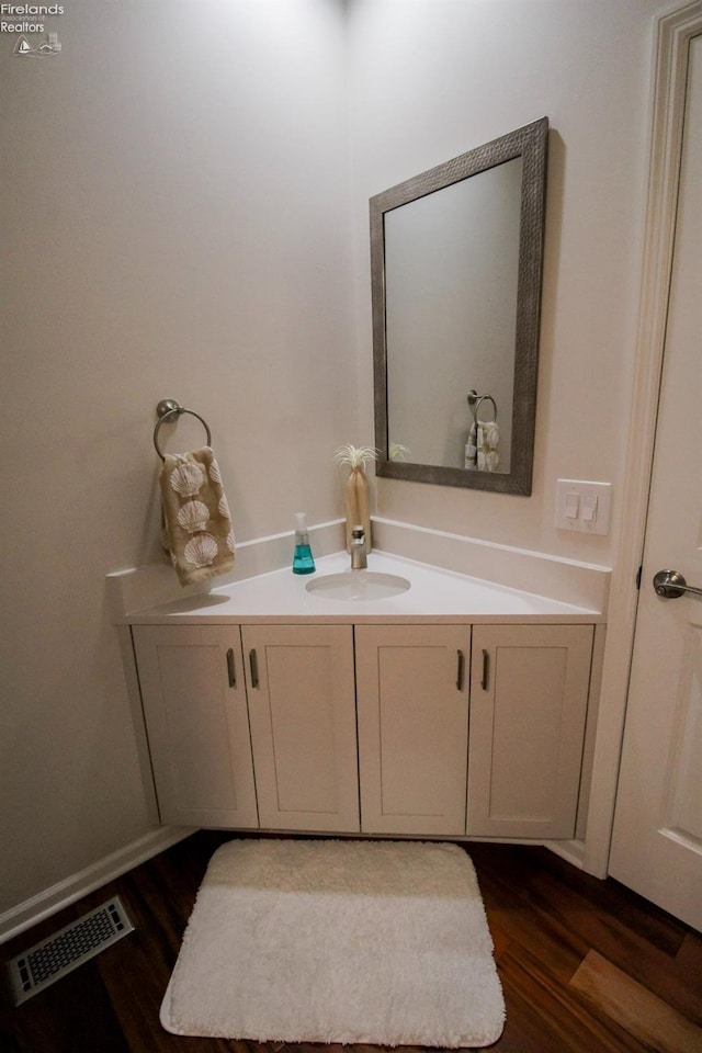 bathroom with vanity and hardwood / wood-style floors