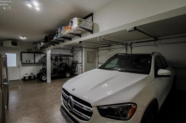 garage featuring stainless steel fridge