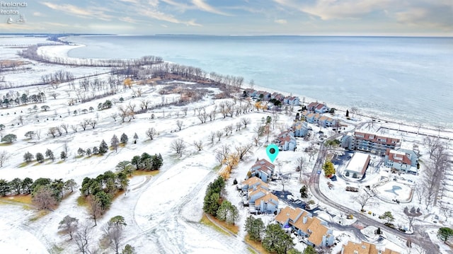 snowy aerial view with a water view