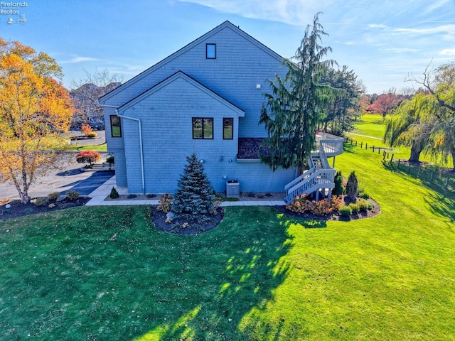 rear view of property with cooling unit and a lawn