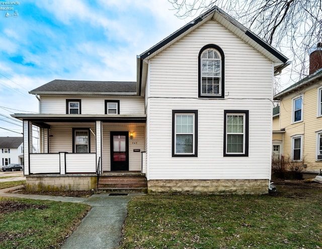 view of front property featuring a porch and a front yard