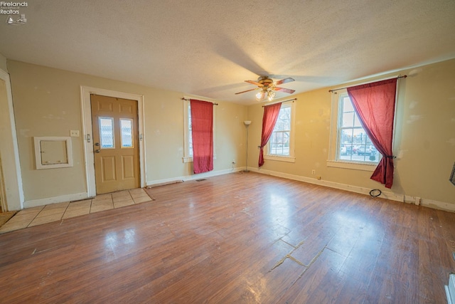 interior space featuring hardwood / wood-style floors, a textured ceiling, and ceiling fan