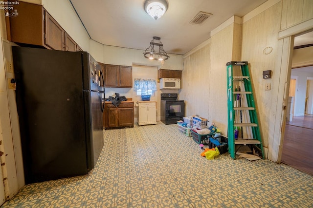 kitchen with black fridge and range