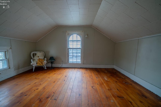 additional living space featuring hardwood / wood-style flooring and lofted ceiling