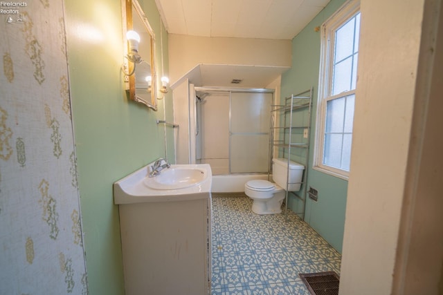 full bathroom featuring enclosed tub / shower combo, vanity, and toilet