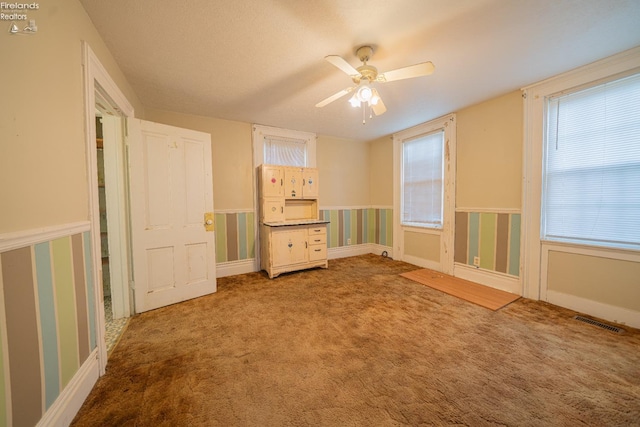 interior space featuring ceiling fan