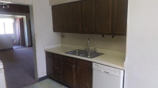 kitchen featuring dark brown cabinetry, dishwasher, and sink