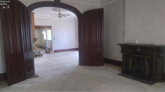 interior space featuring ceiling fan and ornamental molding