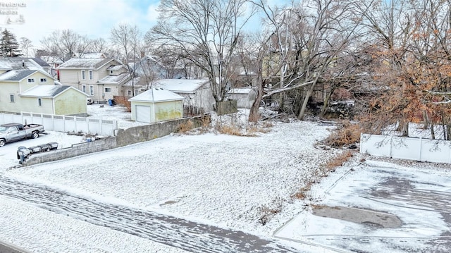 yard covered in snow with a garage