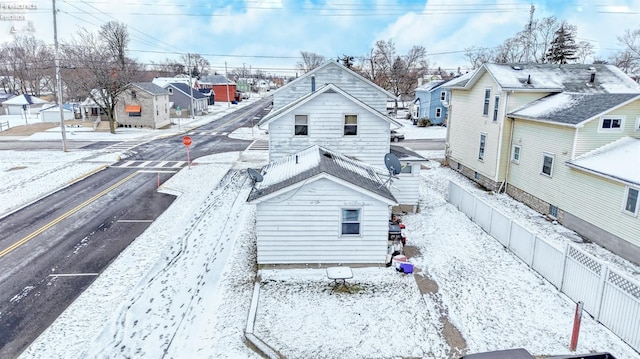 view of snow covered rear of property