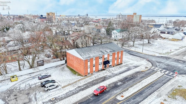 snowy aerial view with a water view