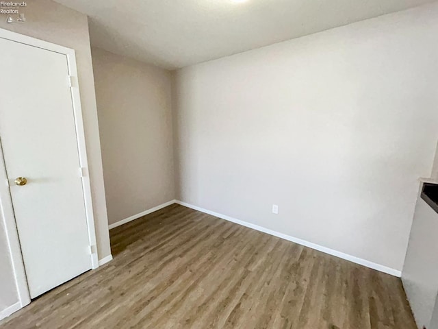 empty room with hardwood / wood-style flooring