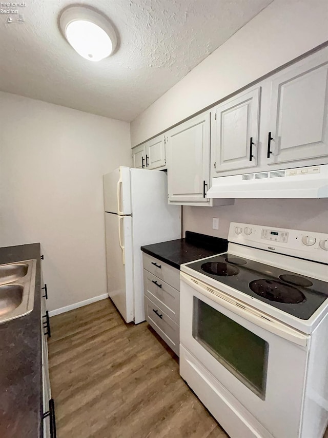 kitchen with white cabinetry, sink, light wood-type flooring, white appliances, and a textured ceiling