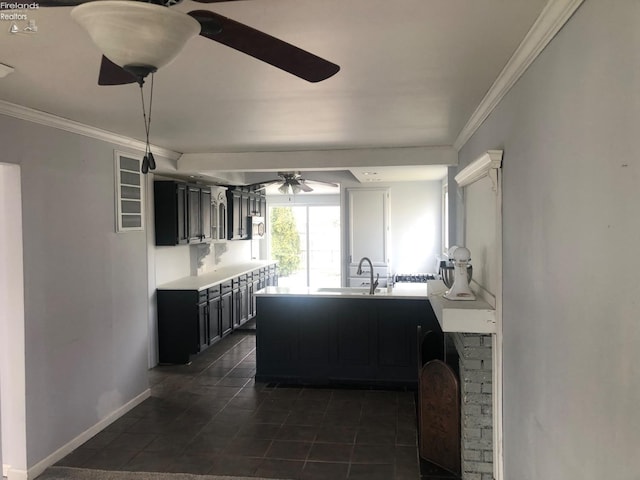 kitchen with sink, crown molding, dark tile patterned floors, and ceiling fan