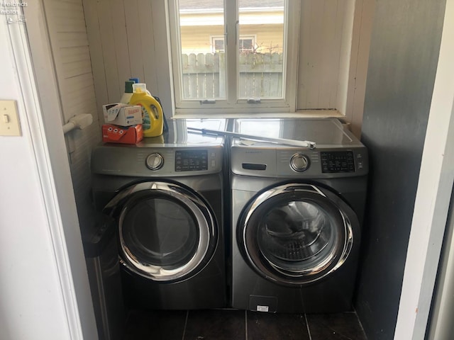 washroom with dark tile patterned flooring and independent washer and dryer