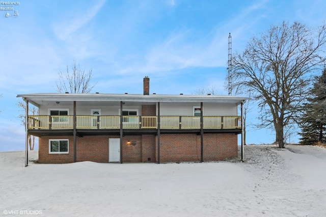 view of snow covered back of property