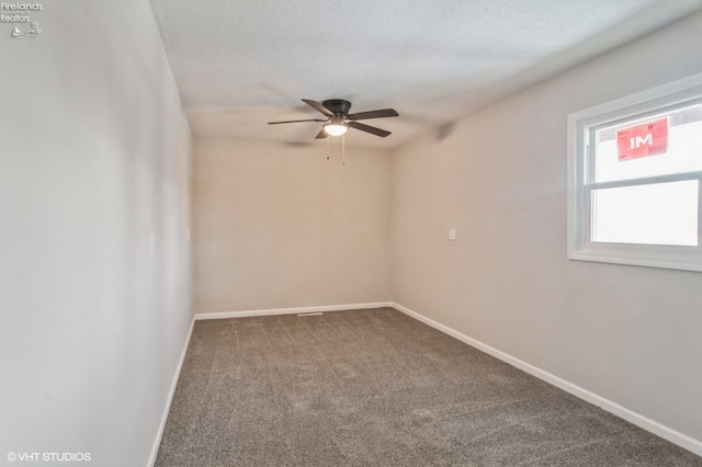 unfurnished room featuring ceiling fan, carpet flooring, and a textured ceiling