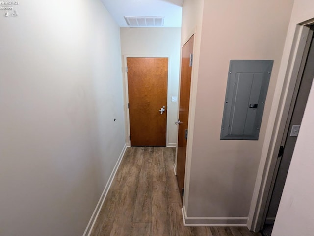 hallway with hardwood / wood-style flooring and electric panel