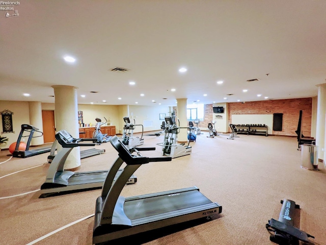 exercise room featuring decorative columns