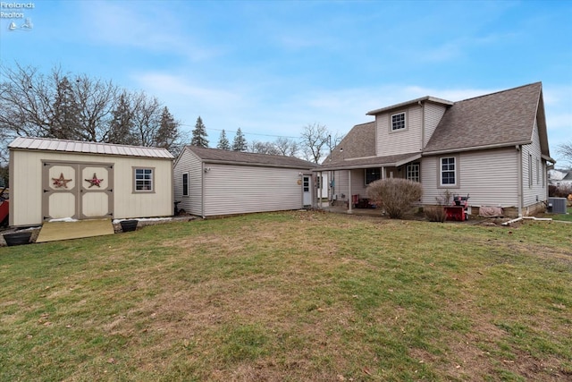 back of house featuring central AC unit, a shed, and a lawn