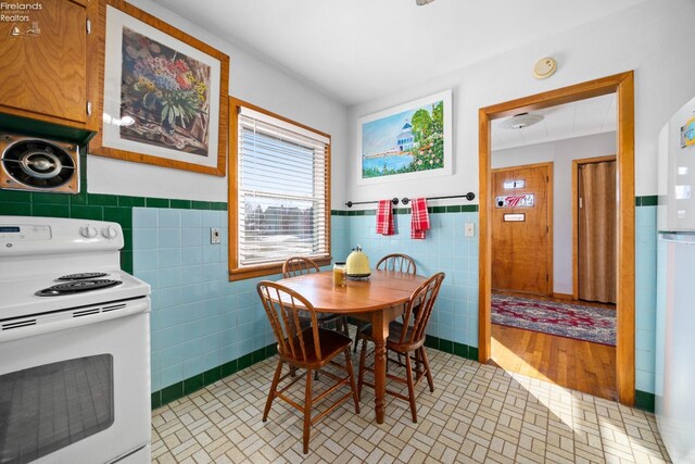 dining room with tile walls