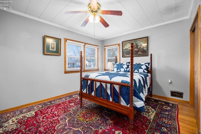 bedroom featuring hardwood / wood-style flooring, ceiling fan, and ornamental molding