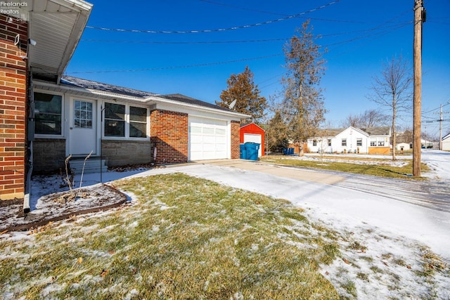 snowy yard with a garage