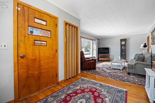 living room featuring crown molding and light wood-type flooring