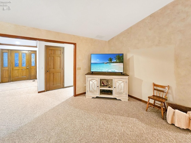 unfurnished living room with lofted ceiling and light carpet