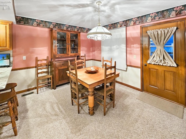 dining area featuring light colored carpet