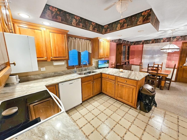 kitchen featuring dishwasher, sink, hanging light fixtures, stove, and kitchen peninsula