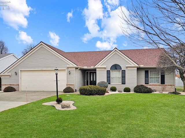 ranch-style home featuring a garage and a front yard