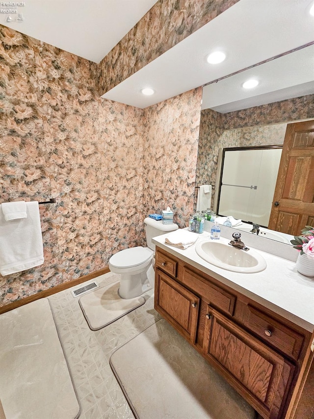 bathroom featuring vanity and toilet