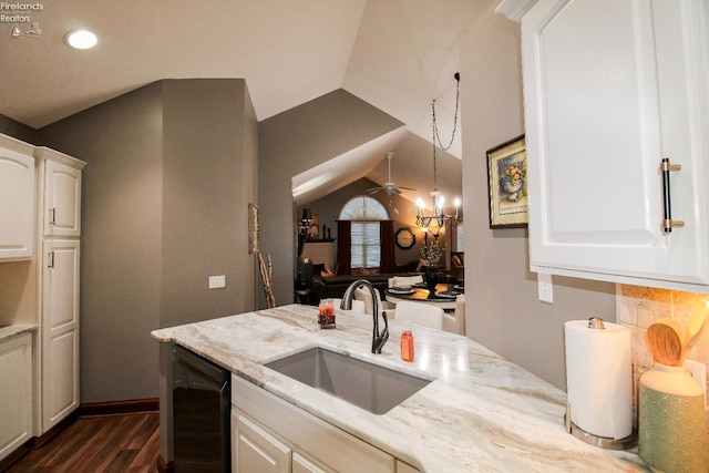 kitchen featuring sink, dishwasher, hanging light fixtures, light stone counters, and white cabinets