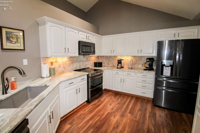 kitchen featuring light stone counters, sink, white cabinets, and appliances with stainless steel finishes