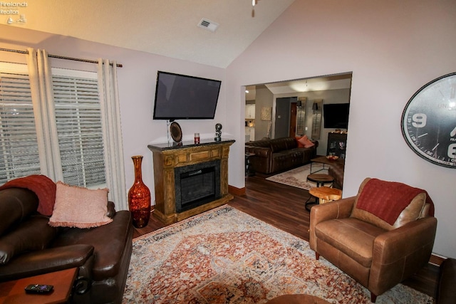 living room with high vaulted ceiling and dark hardwood / wood-style flooring