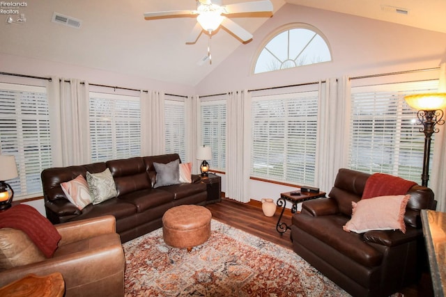 living room featuring hardwood / wood-style flooring, high vaulted ceiling, and ceiling fan