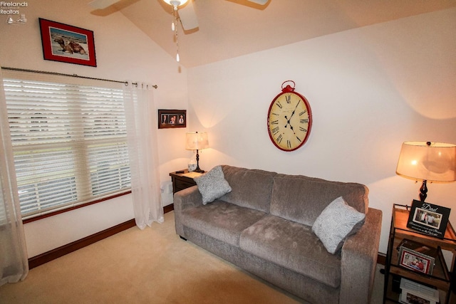 carpeted living room with ceiling fan and lofted ceiling