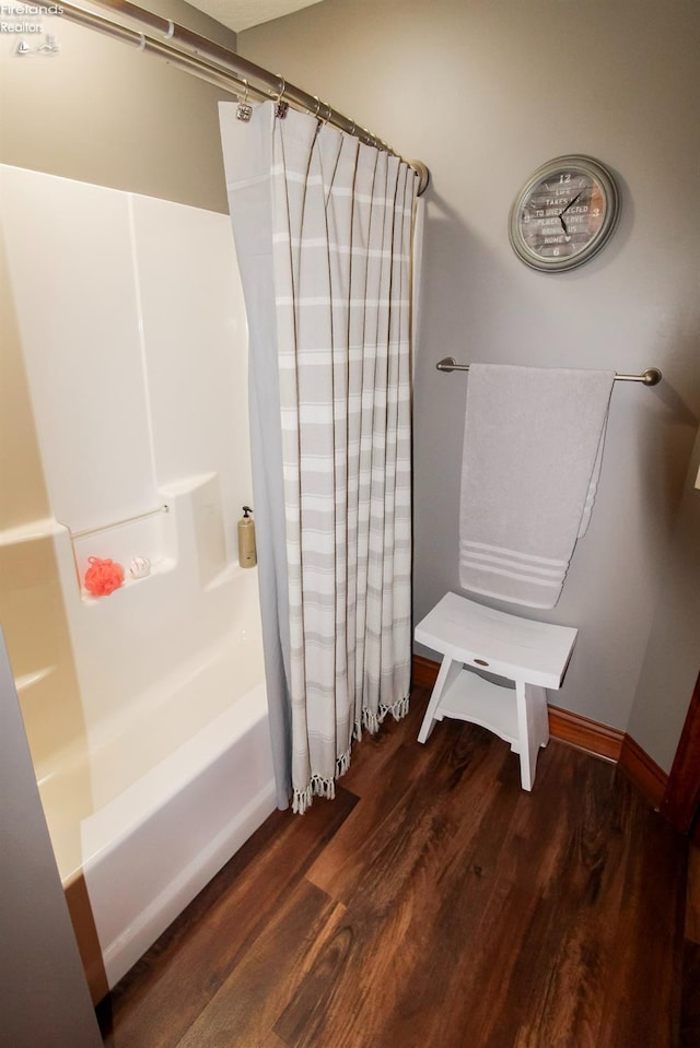 bathroom with shower / bath combination with curtain and hardwood / wood-style flooring