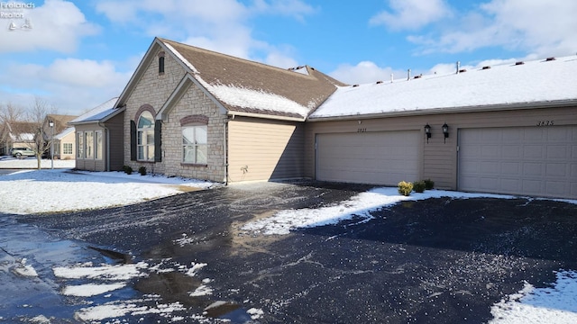 view of snow covered exterior featuring a garage