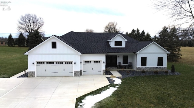 view of front facade with a garage, covered porch, and a front lawn