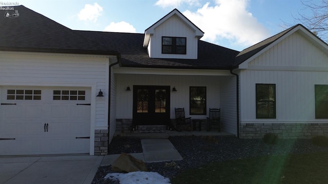 view of front of house featuring a porch and a garage