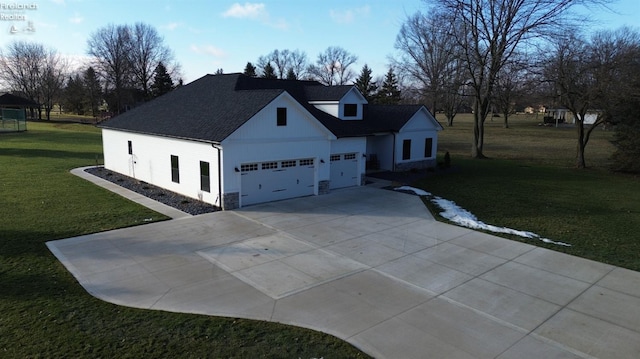 view of front of house featuring a garage and a front lawn