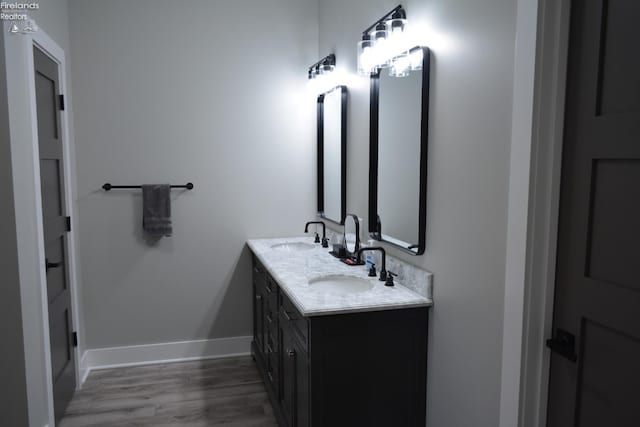 bathroom featuring vanity and wood-type flooring