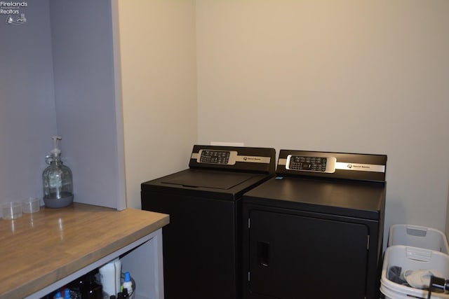 clothes washing area featuring washer and clothes dryer