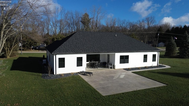 back of house featuring a patio and a yard